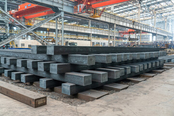Close up photo of steel ingots stacked in the production workshop of a steel plant