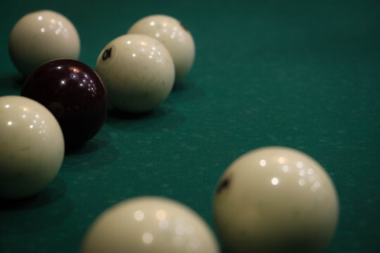 A pool table with a white ball and a red ball