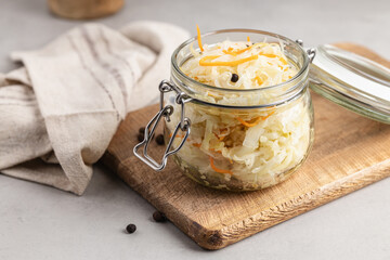 Pickled cabbage. Sauerkraut with carrots in a glass jar.