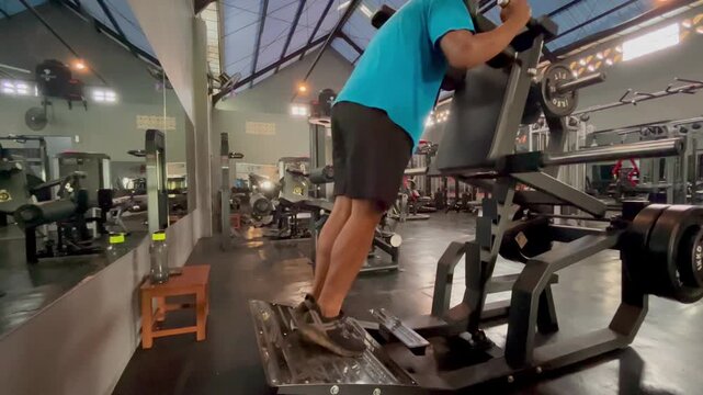 a man who is training his leg muscles at the gym