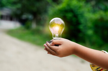 Renewable energy concept Earth Day or environment protection Hands protect forests that grow on the ground and help save the world.