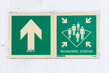Muster Station - Assembly point and direction arrow signs on a ship