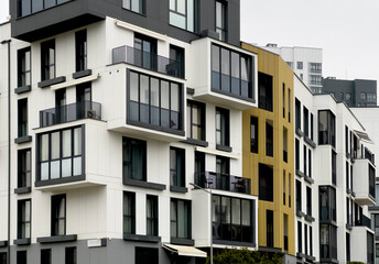 Modern residential apartment block with balconies and clean architectural lines in an urban street