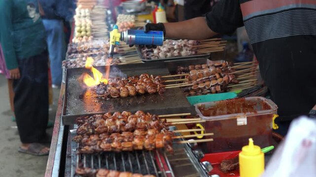 Grilling Bakso Meatball Skewers at Street Food Stall