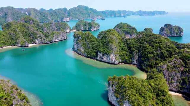 Aerial flyover of limestone islands and boats in Lan Ha Bay, Vietnam