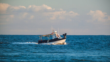 Fishing Boat Cruising Through Deep Blue Sea