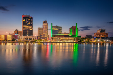 Toledo, Ohio, USA. Cityscape image of downtown Toledo, Ohio with reflection of the skyline in calm Maumee River at beautiful autumn sunset.