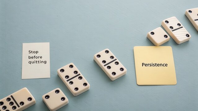 Dominoes in a chain effect with a midfall pause overhead - Powered by Adobe