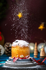 close up of a panettone cake on a table at Christmas with icing sugar