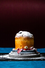 close up of a panettone cake on a table at Christmas with icing sugar with copy space