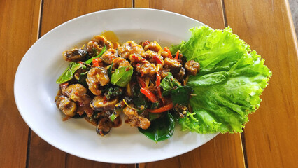 The photograph shows stir-fried freshwater eel in spicy curry paste, a popular dish among Thais and tourists visiting Asia.