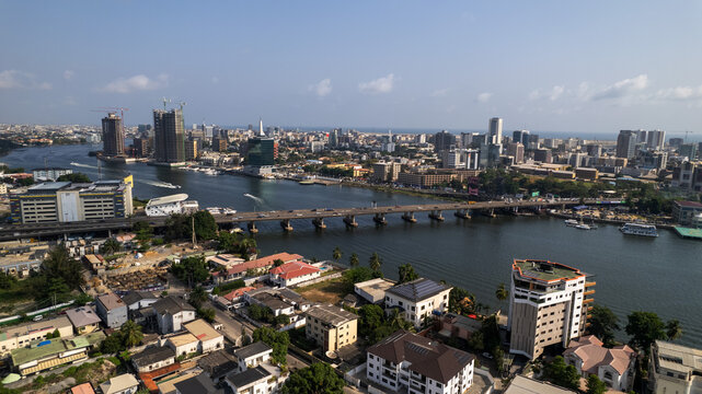 Aerial view of the Falomo Bridge stretching across the Lagos Lagoon, connecting Ikoyi with the mainland under a clear sky, Lagos, Lagos, Nigeria.