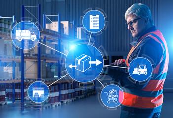 Logistics manager uses tablet in smart warehouse with digital icons for shipping, inventory and order flow, supporting real-time supply chain and fulfillment control.