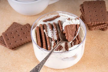 Fototapete Zu Essen Simple two ingredient yogurt cheesecake in glass, viral tasty quick recipe made with greek yogurt and chocolate biscuits, copy space  © ricka_kinamoto