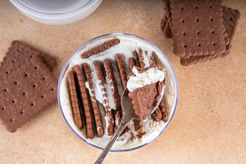 Simple two ingredient yogurt cheesecake in glass, viral tasty quick recipe made with greek yogurt and chocolate biscuits, copy space