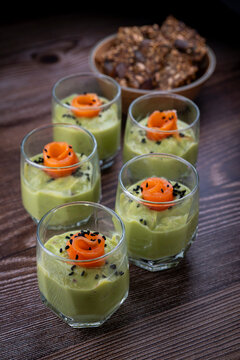Smoked salmon shot glasses guacamole served with homemade crackers. High quality photo