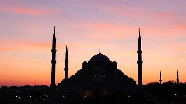 Silhouette of a grand mosque with multiple minarets against a vibrant sunset sky, showcasing Islamic architecture and spiritual beauty.