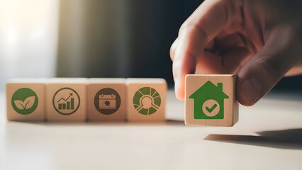 Hand Holding Wooden Block with Green House Icon and Checkmark image photo