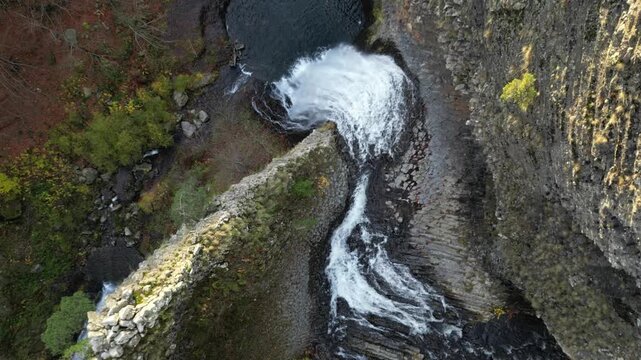 Slow motion autumn drone aerial of Ray Pic Waterfall in France &ndash; volcanic basalt falls in Ardeche