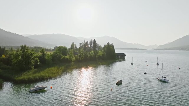 Aerial view of Wolfgangsee lake Austria. Boats and boats stand on the pier in the lake in a beautiful landscape of the Alpine mountains.