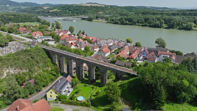 Aerial view of the old viaduct in Austria. Historic railway bridge in a tourist town.
