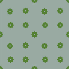 Green gear-like shapes evenly distributed on a light blue background form a seamless pattern. 