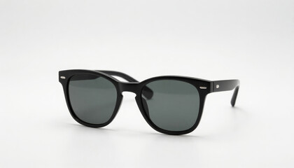 Stylish black sunglasses with dark lenses resting on a clean white background, ideal for summer fashion and eye protection