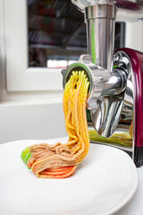 Grinding turkish delight with an electric meat grinder, colorful gradient soft sugar paste, close up