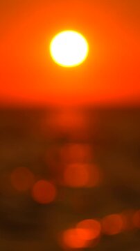 Sunset, ocean, bokeh, golden hour over water, romantic reflection, evening nature, vertical video