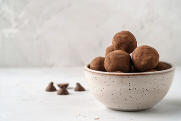 Chocolate truffles arranged in a minimalist ceramic bowl with a soft background, showcasing rich textures and inviting ambiance for dessert lovers and culinary enthusiasts