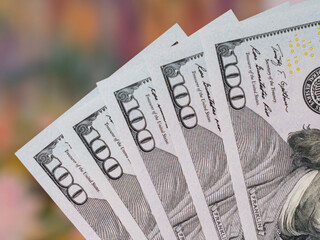 Close-Up of Five Hundred Dollar Bills on Colorful Background
