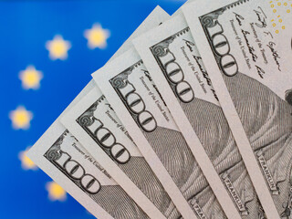 Close-Up of Five Hundred Dollar Bills on Euro Flag Background