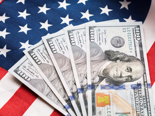 American Dollars on a Background of the U.S. Flag