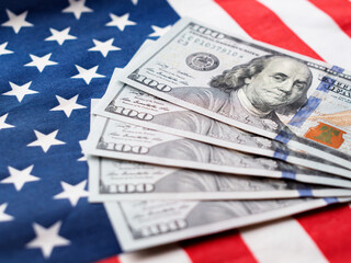 US Dollar Bills on American Flag Background