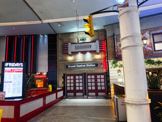 Naklejka premium Inside Grand Central Station Manchester featuring Fridays restaurant, Subway sign, and retro neon decor