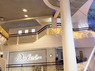 Naklejka premium Dolci shop interior in Manchester mall with festive lights and nautical decor