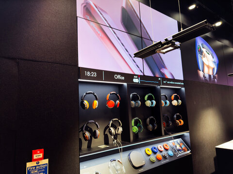 Headphone display at Manchester Dyson store showcasing colorful over ear headphones on wall
