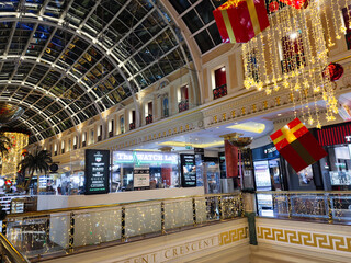 Fototapeta premium Festive lights illuminate Manchester Trafford Centre shopping mall with luxury stores and holiday decor