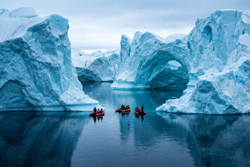 Extreme adventure in Antarctic on inflatable boats. Beautiful frozen landscape with massive Iceberg pieces of ice reflecting on water surface. Travel background