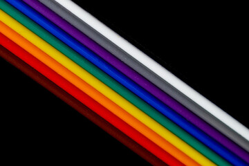 Multicolored wires isolated on black background. Close-up.