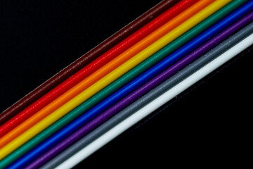 Multicolored wires isolated on black background. Close-up.