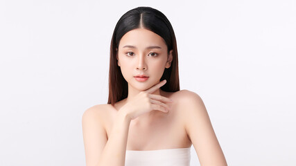 A beautiful young Asian woman with clean, fresh skin against a white background. Skincare, facial treatment, cosmetology, beauty, and spa. An elegant portrait of an Asian woman.