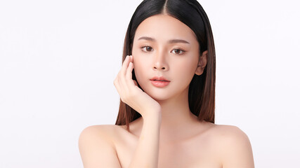 A beautiful young Asian woman with clean, fresh skin against a white background. Skincare, facial treatment, cosmetology, beauty, and spa. An elegant portrait of an Asian woman.