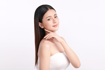 A beautiful young Asian woman with clean, fresh skin against a white background. Skincare, facial treatment, cosmetology, beauty, and spa. An elegant portrait of an Asian woman.