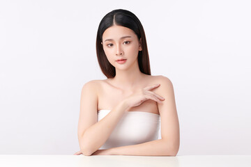 A beautiful young Asian woman with clean, fresh skin against a white background. Skincare, facial treatment, cosmetology, beauty, and spa. An elegant portrait of an Asian woman.