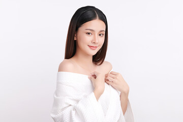 A beautiful young Asian woman with clean, fresh skin against a white background. Skincare, facial treatment, cosmetology, beauty, and spa. An elegant portrait of an Asian woman.