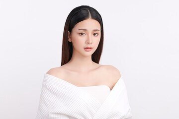 A beautiful young Asian woman with clean, fresh skin against a white background. Skincare, facial treatment, cosmetology, beauty, and spa. An elegant portrait of an Asian woman.