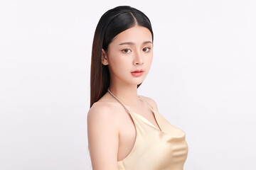 A beautiful young Asian woman with clean, fresh skin against a white background. Skincare, facial treatment, cosmetology, beauty, and spa. An elegant portrait of an Asian woman.