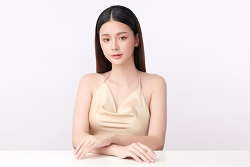 A beautiful young Asian woman with clean, fresh skin against a white background. Skincare, facial treatment, cosmetology, beauty, and spa. An elegant portrait of an Asian woman.
