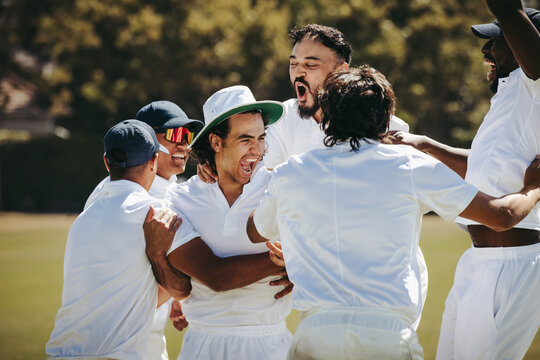 Cricket players celebrating their victory with excitement and teamwork outdoors
